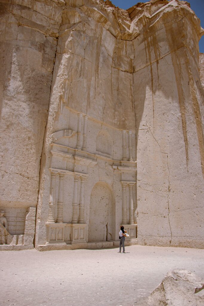 Explore stunning ancient stone carvings in the desert landscape of Arequipa, Peru with a solitary traveler.